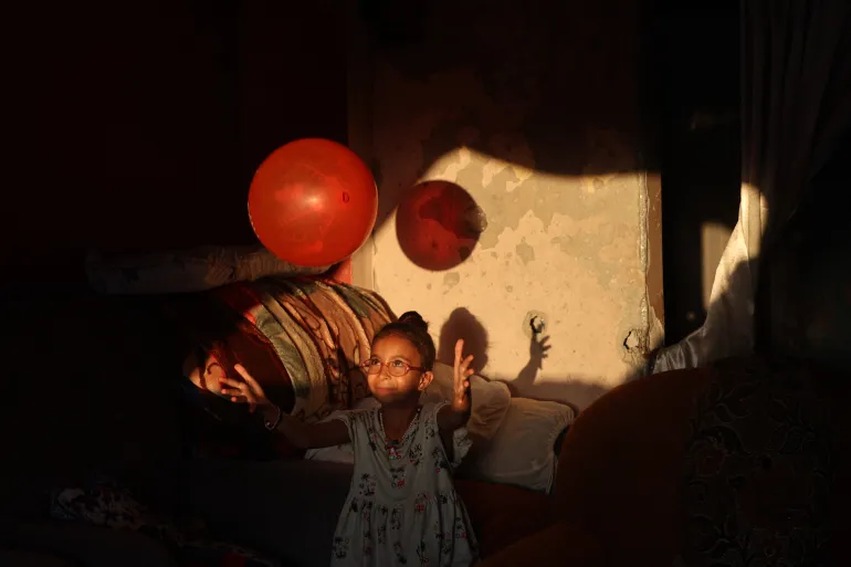 Palestinians living among the rubble in Bureij refugee camp